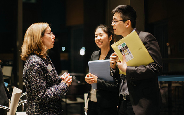 students speaking with career coach at networking event