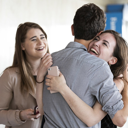Students hugging at the Top of the Hub