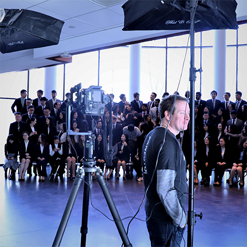 Photographer prepares equipment before taking a class photo.