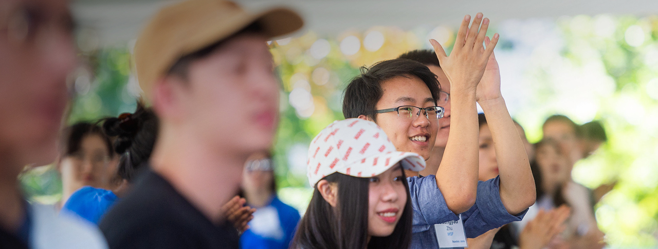 Group of students clapping during orientation