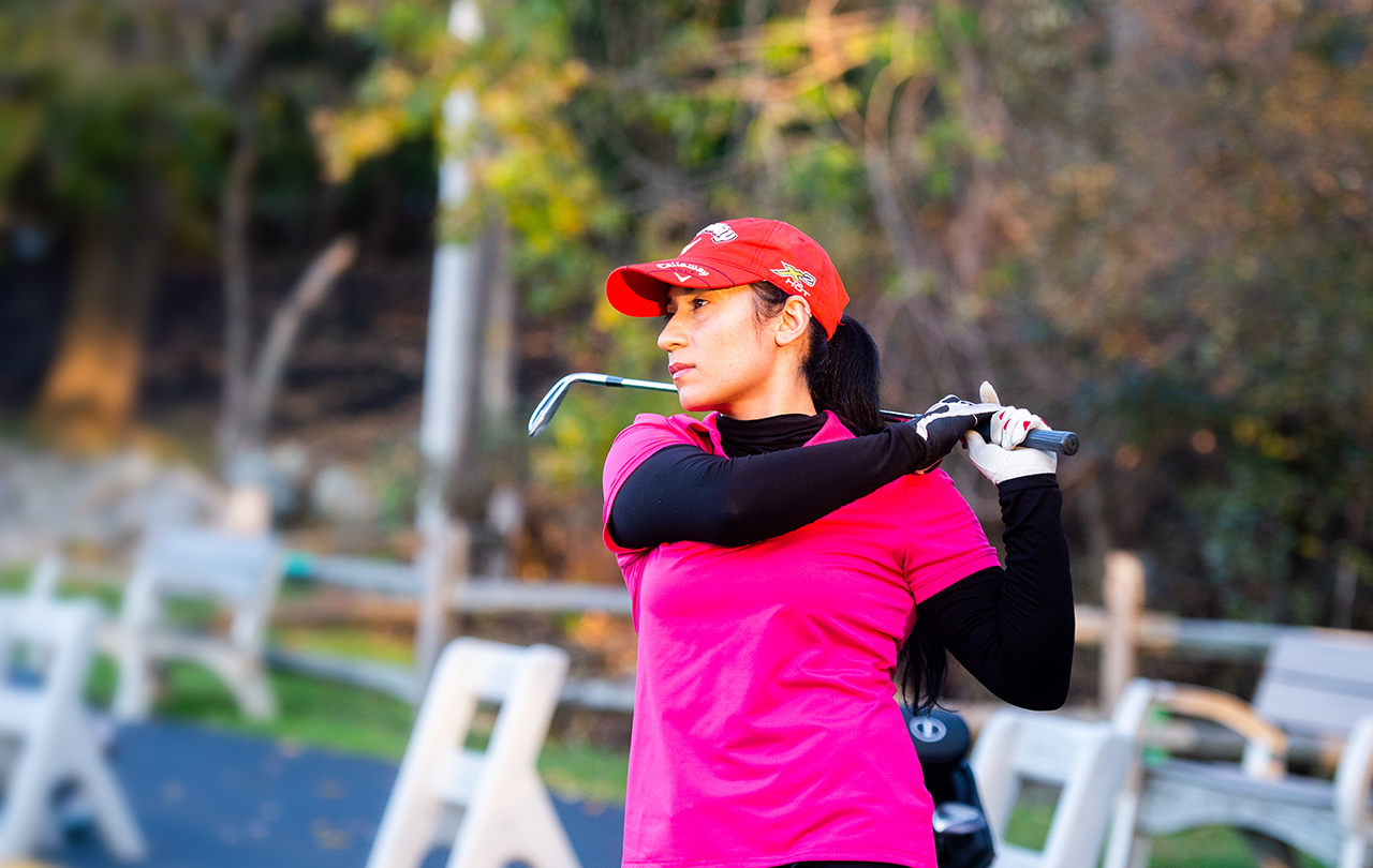 Shagufa Habibi, MA’23 golfing at the driving range