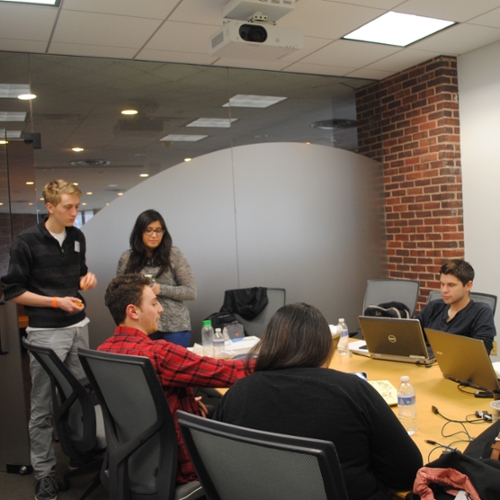 One of the teams holds a meeting in a conference room.