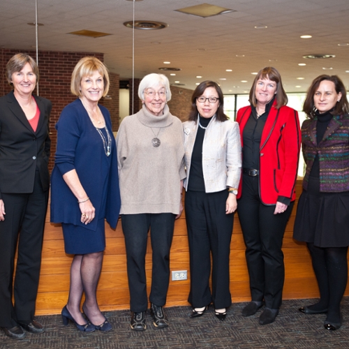 The panel of World Ready Women pose in front of the theater.