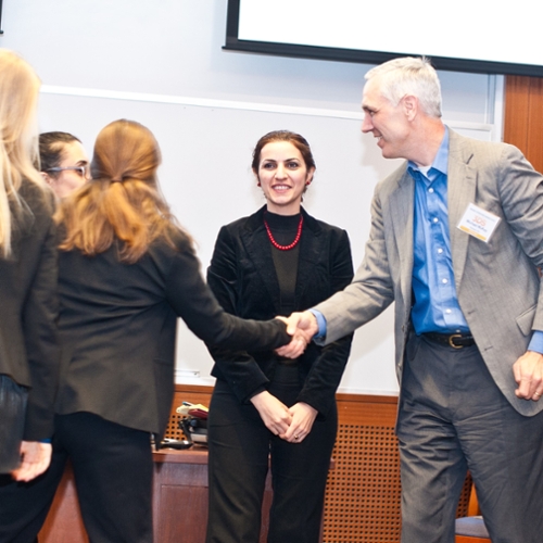 A participant shakes hands with a judge.