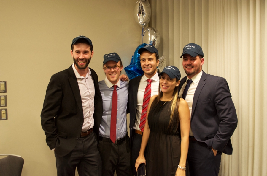 Students posing in Brandeis IBS hats.