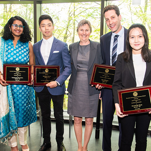students holding awards standing with Senior Associate Dean Katy Graddy