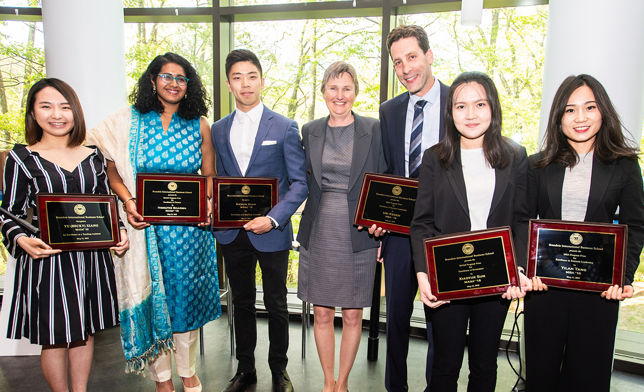 Incoming Dean Kathryn Graddy, middle, with several award winners. In all, eight students, two faculty members and two staff members were honored.