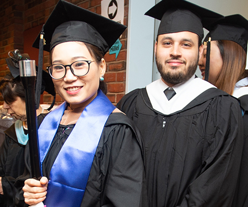 two students in cap and gown