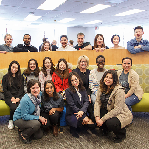 Adjunct Professor Gene Miller (middle row, third from right) with students and staff.