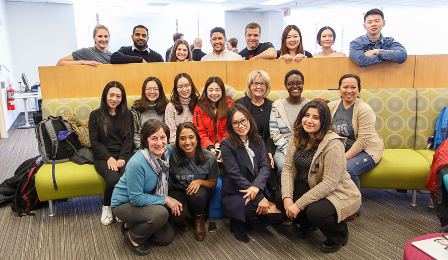 Adjunct Professor Gene Miller (middle row, third from right) with students and staff.