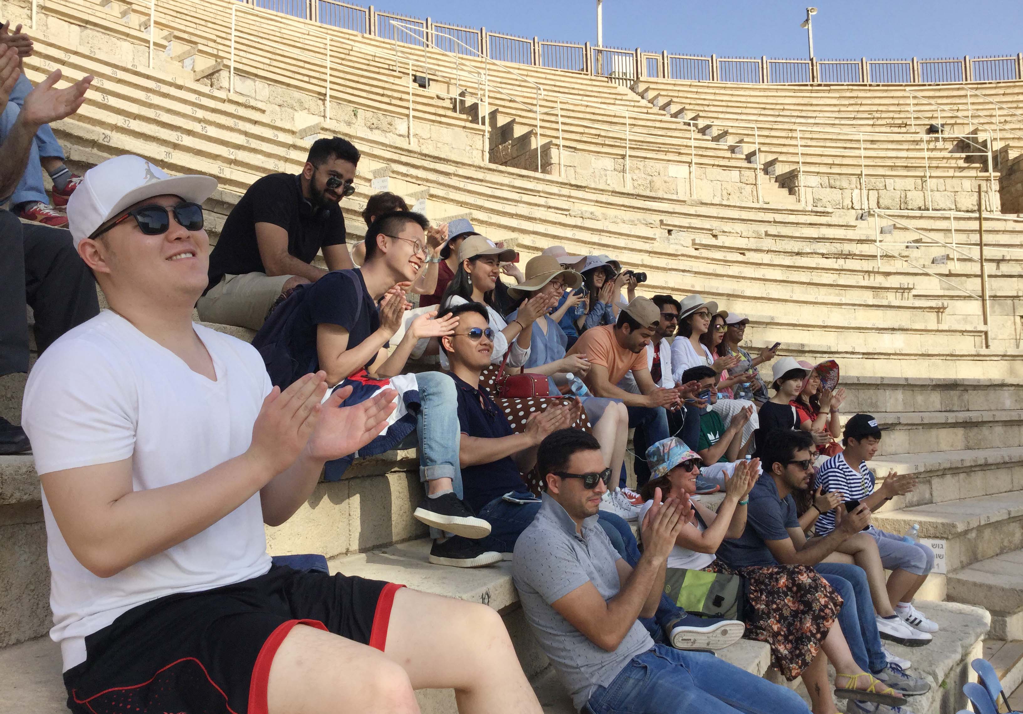 The fellows sit inside the Caesaria amphitheater.