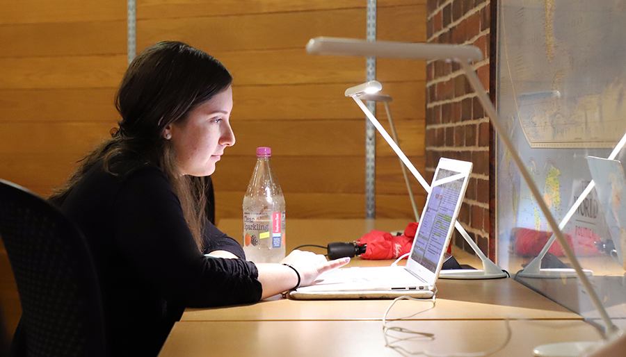 A student studies in front of a laptop computer.