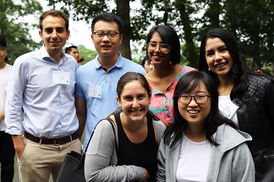 Students pose for a group photo outside.