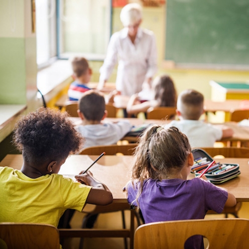 Students and a teacher in a classroom.