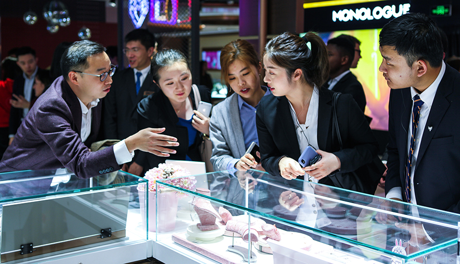 Fellows admire Chou Tai Fouk jewelry 