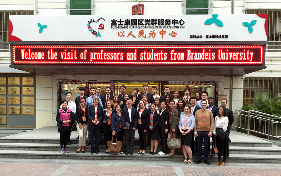 Fellows pose together outside the Foxconn office in Shenzhen, China.