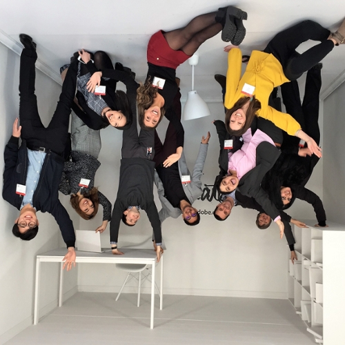 Students pose upside-down at Adobe.