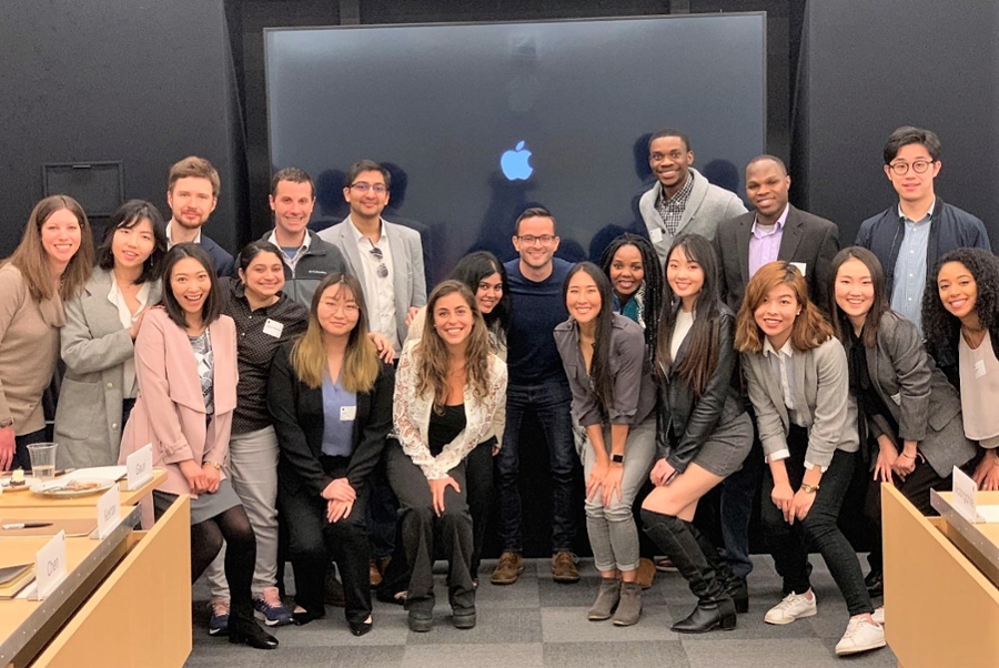 Students pose inside Apple headquarters.