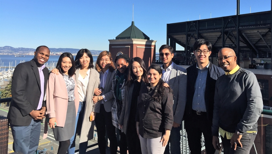 Students pose on a roof deck.