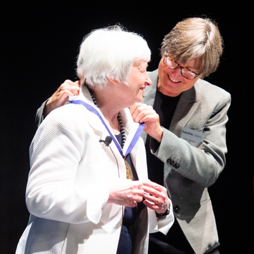 Dean Kathryn Graddy bestows dean's medal to Janet Yellen.
