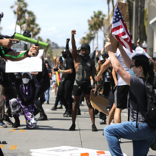 Police and protesters square off on the street.