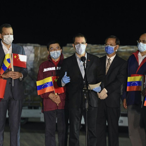 The foreign minister of Venezuela speaks flanked by representatives from China.