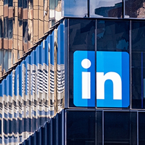 LinkedIn's logo on a glass building.