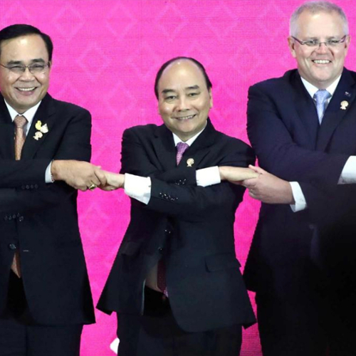 Several East Asian foreign ministers forming a human chain.