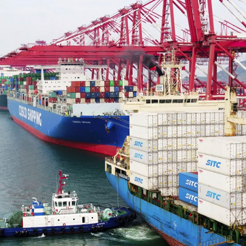 A line of large container ships docked at port in Qingdao, China.