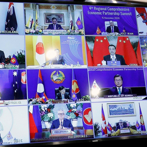 East Asian diplomats in a Zoom meeting on a large screen.