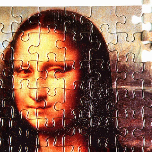 An image of the Mona Lisa as a jigsaw puzzle with a couple pieces not in place.