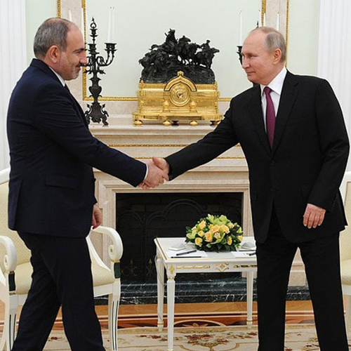 Armenian Prime Minister Nikol Pashinyan shakes hands with Russian President Vladimir Putin