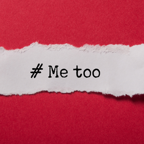 A torn white piece of paper with the text "#MeToo" over red paper.