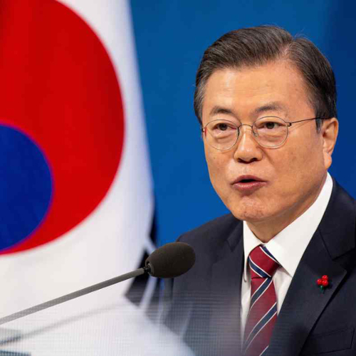 A photo of South Korean President Moon Jae-in speaking at a podium with the South Korean flag in the background.