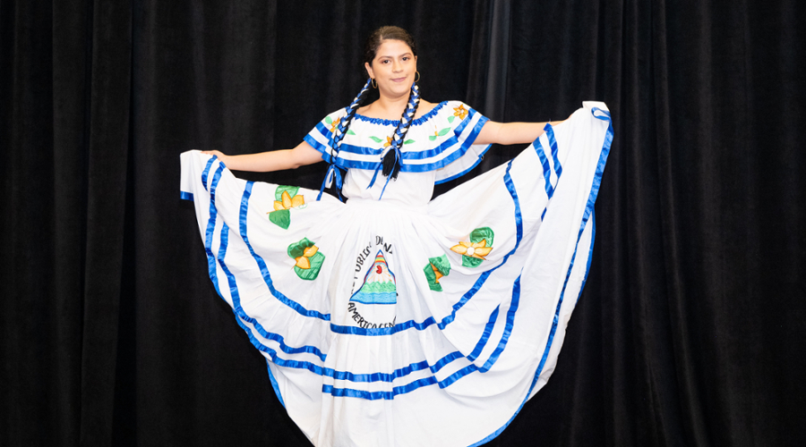 A student holds up the hem of her dress.