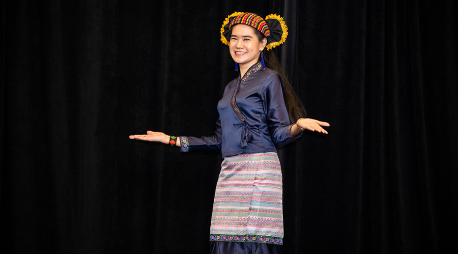 A student on the runway in traditional Myanmar dress.