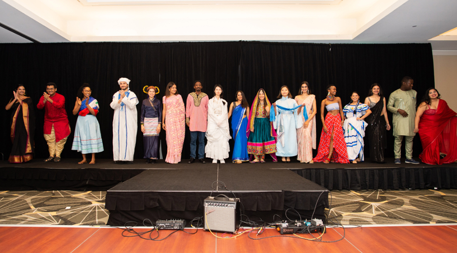 All the students who wore traditional dress line up together on stage.