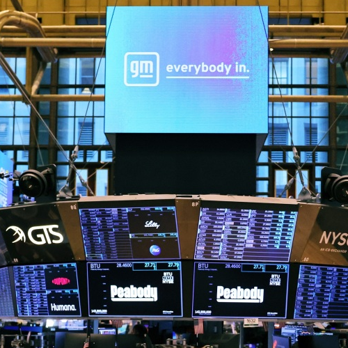 Image of traders working on the floor of the New York Stock Exchange during morning trading
