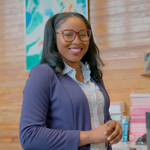 Djounia Saint-Fleurant poses and smiles for a picture in the cluster study area.