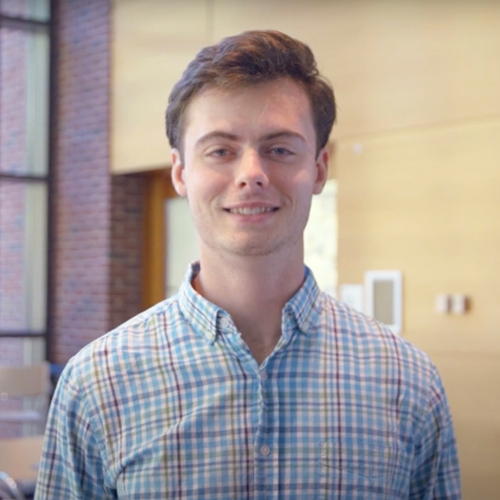 A portrait of Evan Goddard with the Sachar cluster in the background.