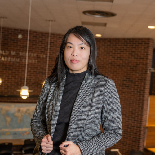 A photo of Michelle Guan dressed in a gray jacket in the student cluster.