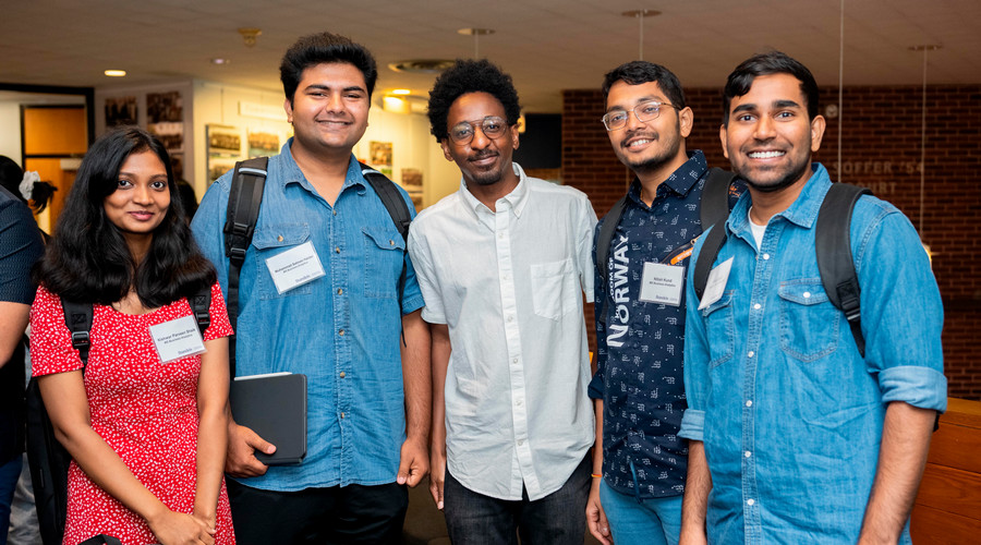 George Nekwaya, MBA’24, center, greets new Brandeis International Business School students.