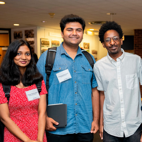 Three students stand together before an orientation event.