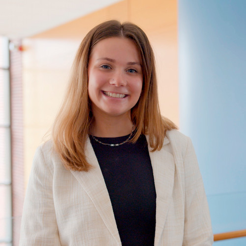 A portrait of Stephanie Borr in professional dress.