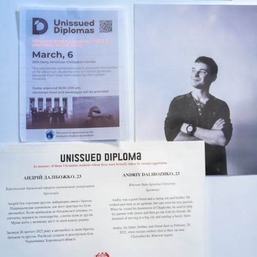 Image of the Ukrainian memorial exhibit. A portrait of a young Ukrainian man next to his unissued diploma.