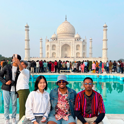 Students pose in front of the Taj Mahal.