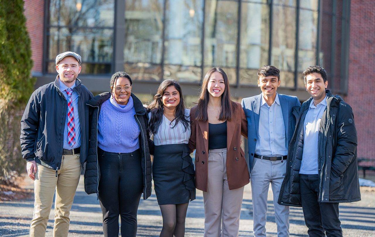 students smiling outside of business school