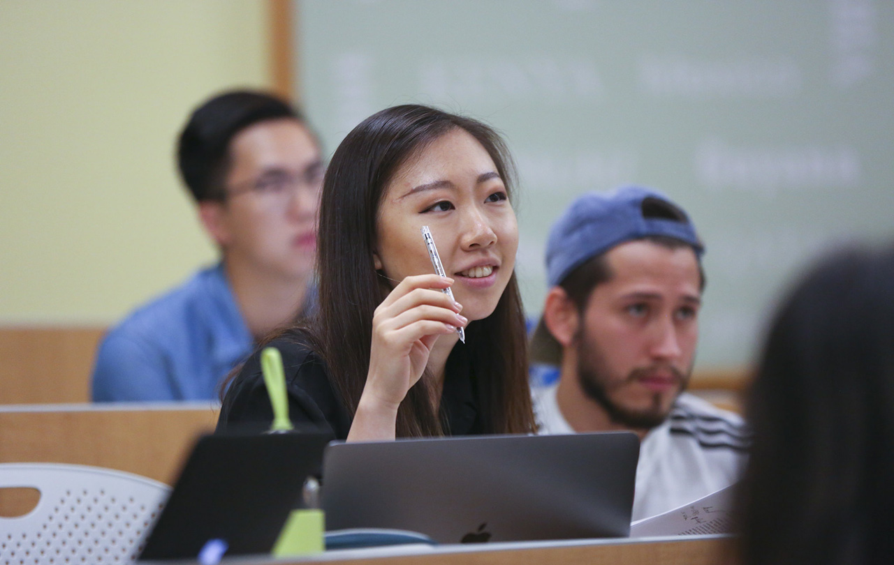 Student raising her hand in classroom