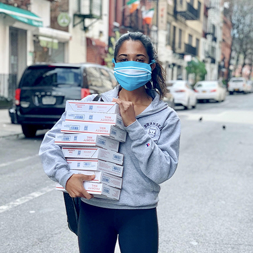 Nimisha Shinday ’17, MA ’18 holding USPS packages