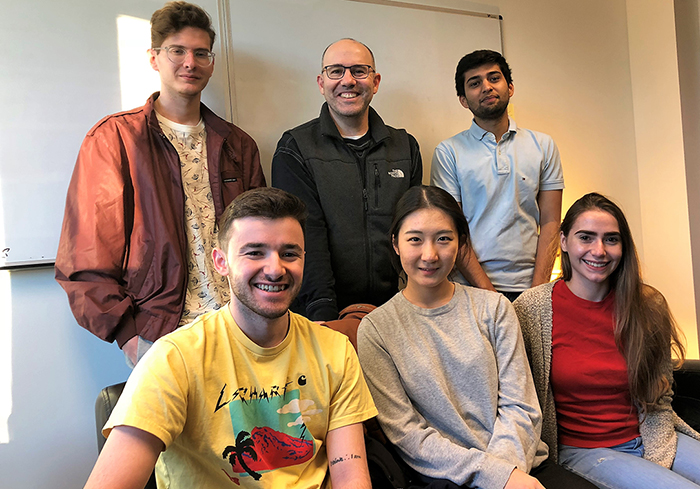 Host Andy Molinsky (back row, center) and his podcast team.